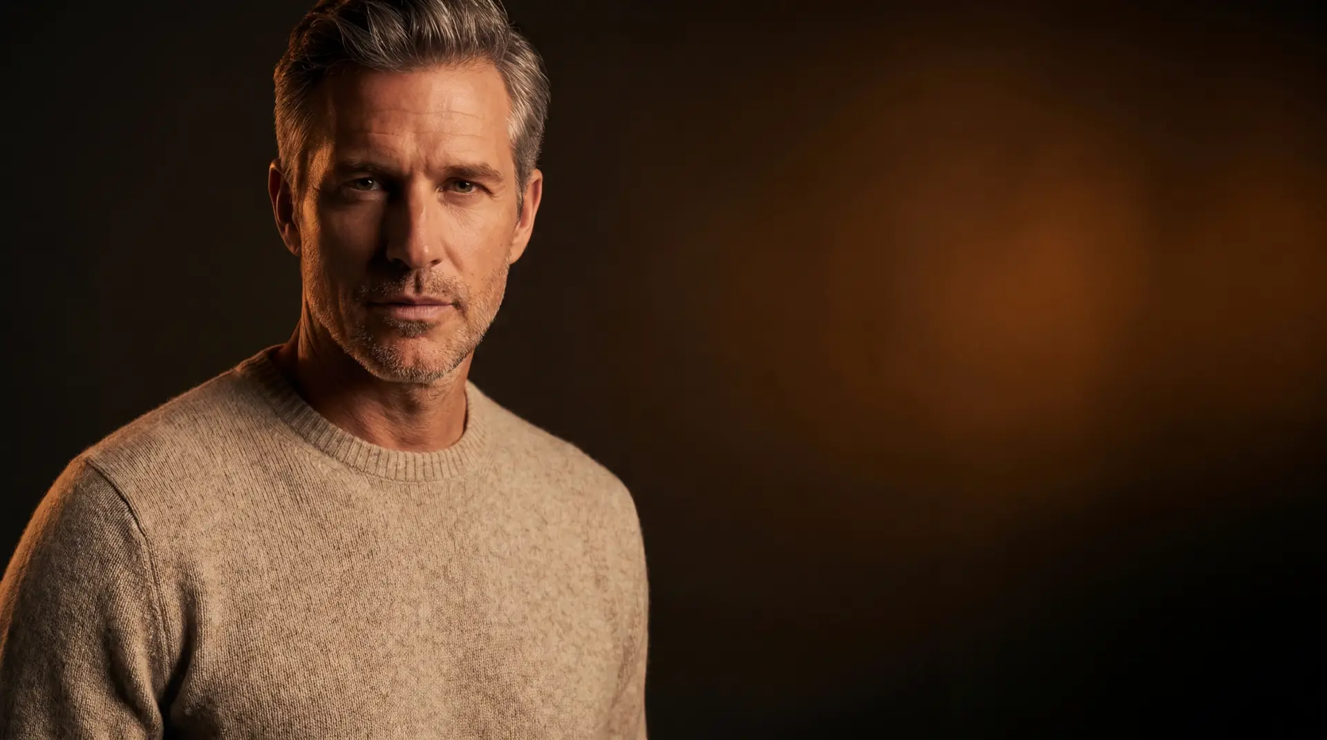 A confident, composed man in a calm, considered setting